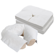 Soft cloth-like disposable face cradle covers shown stacked and placed over a massage table headrest cover on white background